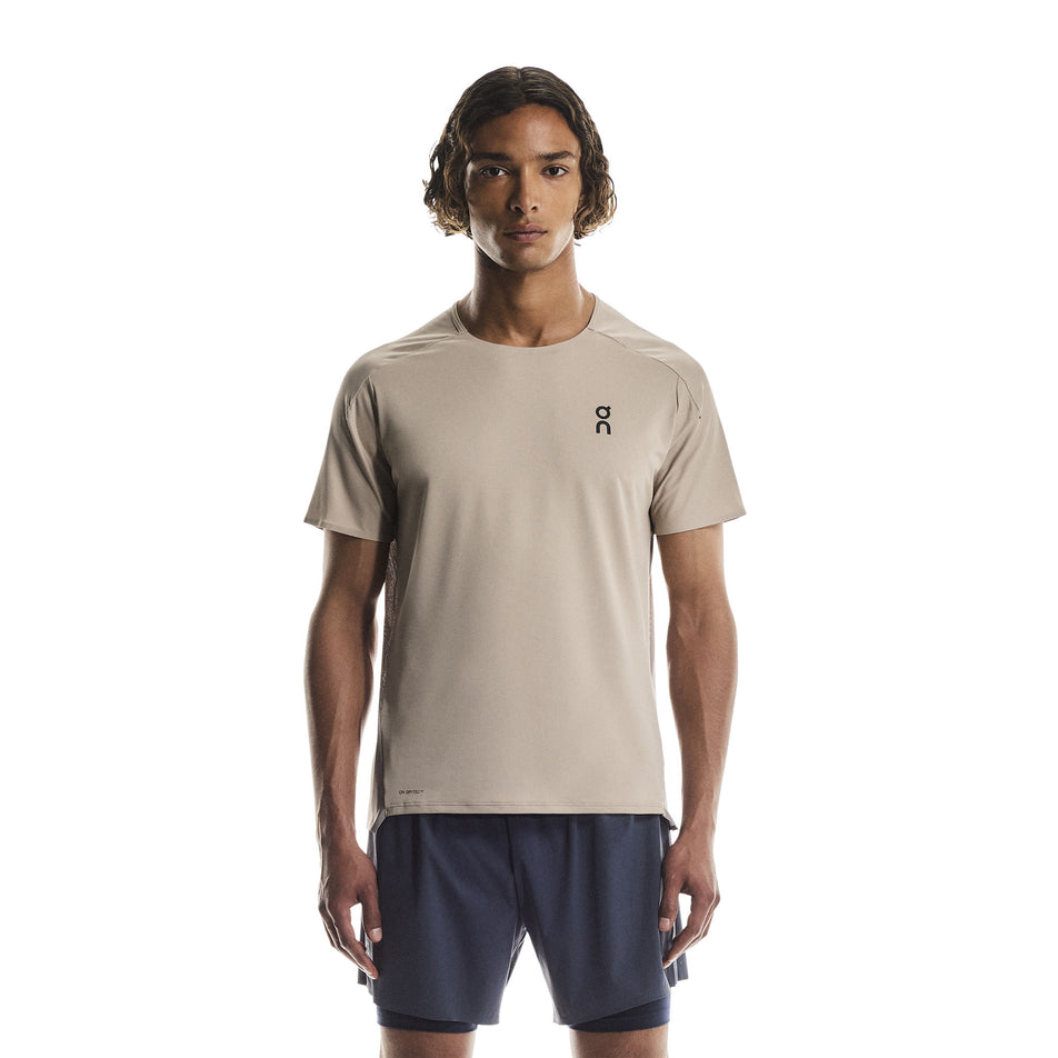 Front view of a model wearing the On Men's Performance-T in the Desert/Cinder colourway.