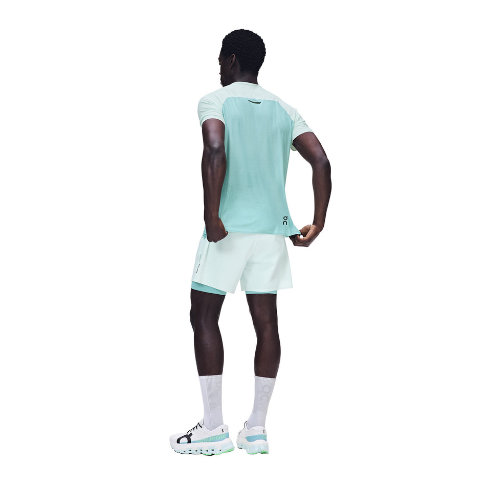 Back view of a model wearing the On Men's Performance-T in the Flurry/Aquamarine colourway.