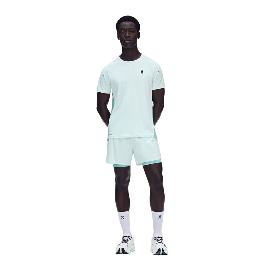 Front view of a model wearing the On Men's Performance-T in the Flurry/Aquamarine colourway.