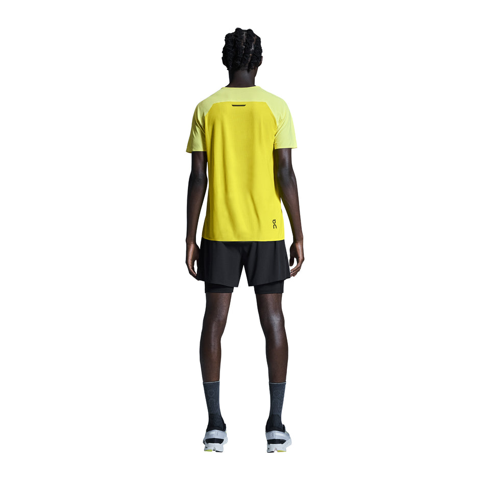 Back view of a model wearing the On Men's 5