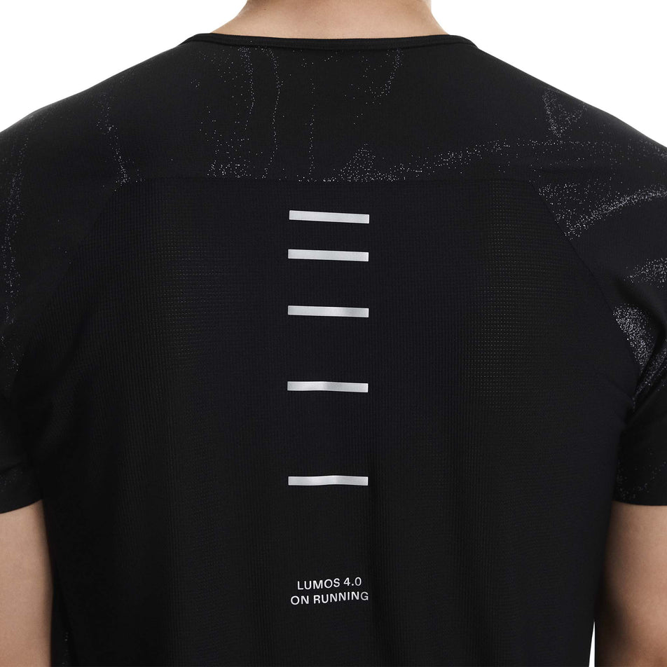 Back view of a model wearing the On Men's Performance-T Lumos in the Black colourway. (8790109946018)