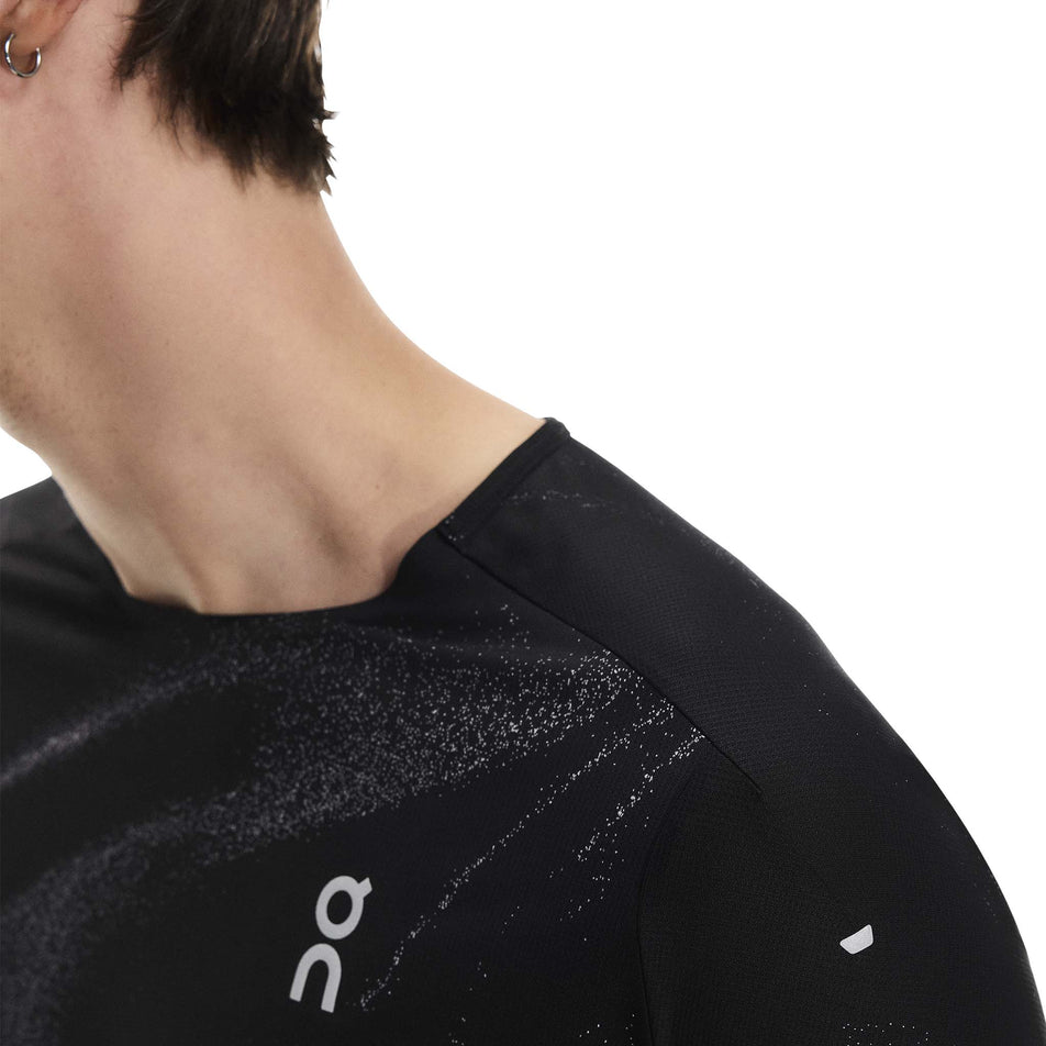 Close-up view of the neckline on the On Men's Performance-T Lumos in the Black colourway. (8790109946018)