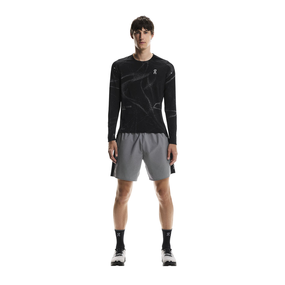 Front view of a model wearing the On Men's Performance Long-T Lumos in the Black colourway. (8790118105250)