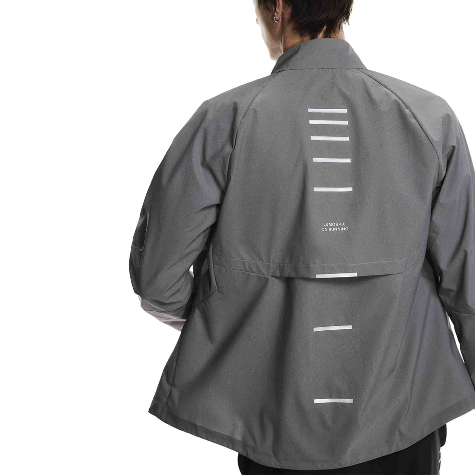 Back view of a model wearing the On Men's Weather Jacket Lumos in the Eclipse colourway. (8790125510818)
