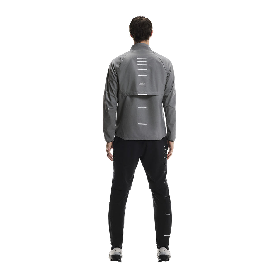 Back view of a model wearing the On Men's Weather Jacket Lumos in the Eclipse colourway. (8790125510818)