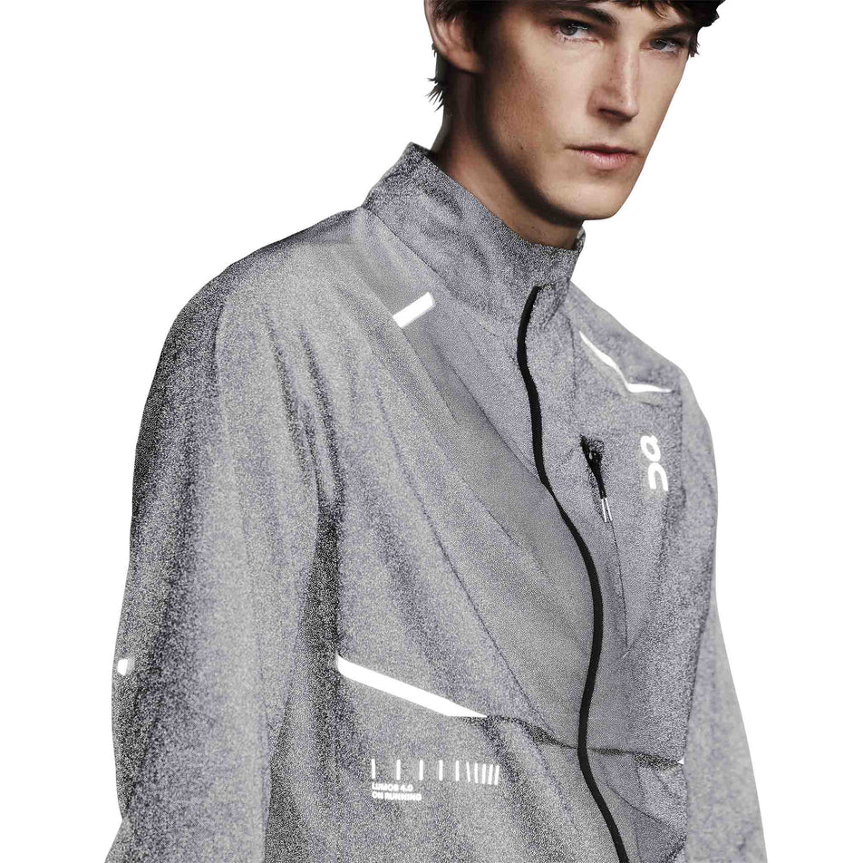 The reflective detail on the On Men's Weather Jacket Lumos in the Eclipse colourway. (8790125510818)