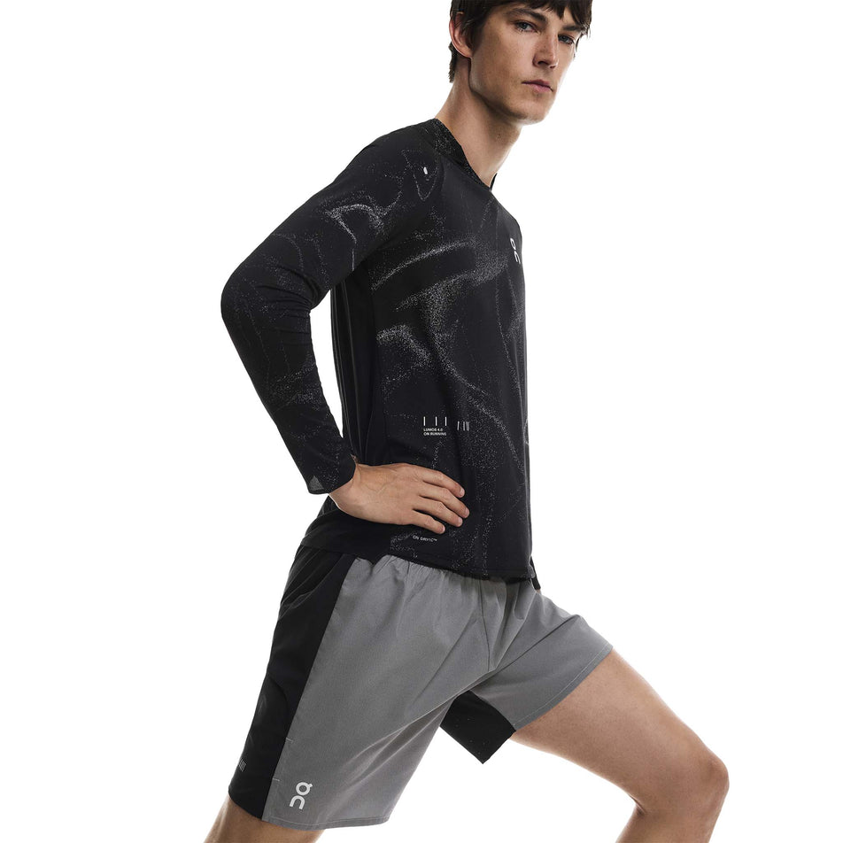 Angled view of a model wearing the On Men's Performance Shorts Lumos in the Eclipse/Black colourway. (8790133473442)
