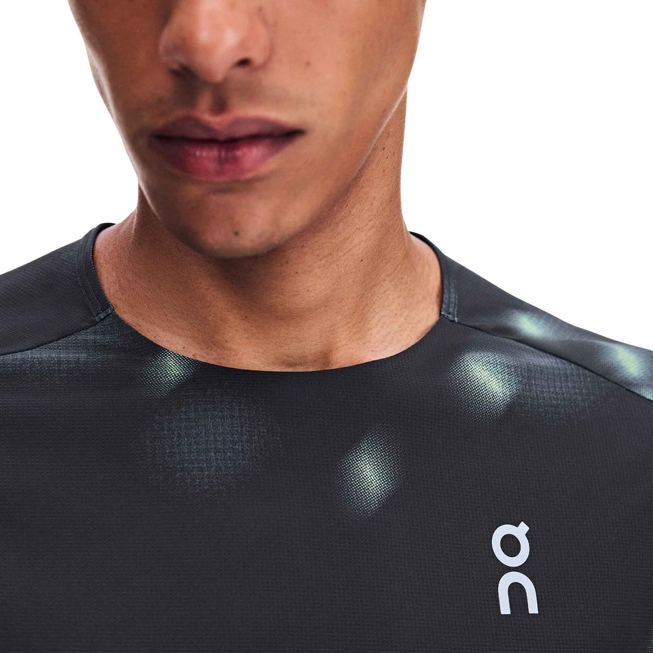 Close-up view of the chest and neckline of the On Men's Performance-T Lumos 2.0 in the Black colourway.