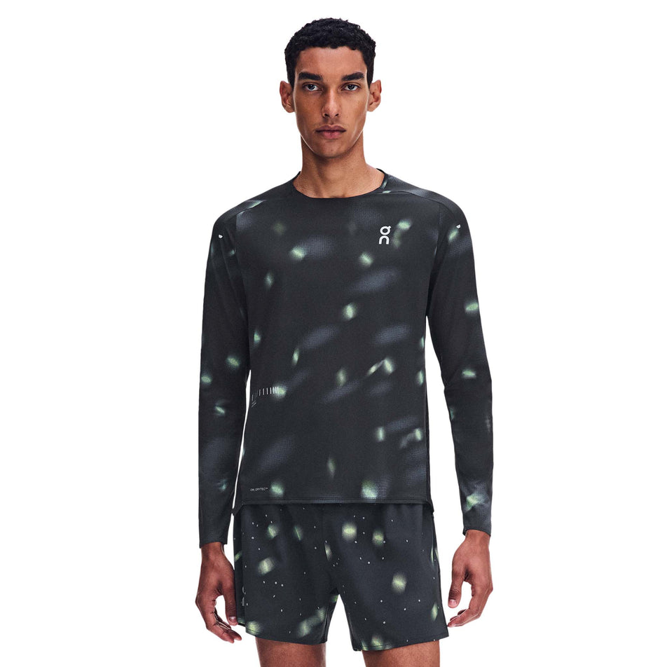 Front view of a model wearing the On Men's Performance Long-T Lumos 3.0 in the Black colourway.
