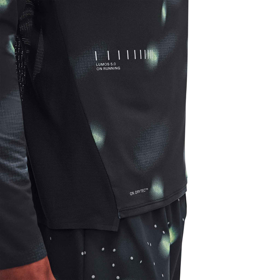 Close-up view of the Lumos branding on the On Men's Performance Long-T Lumos 3.0 in the Black colourway.