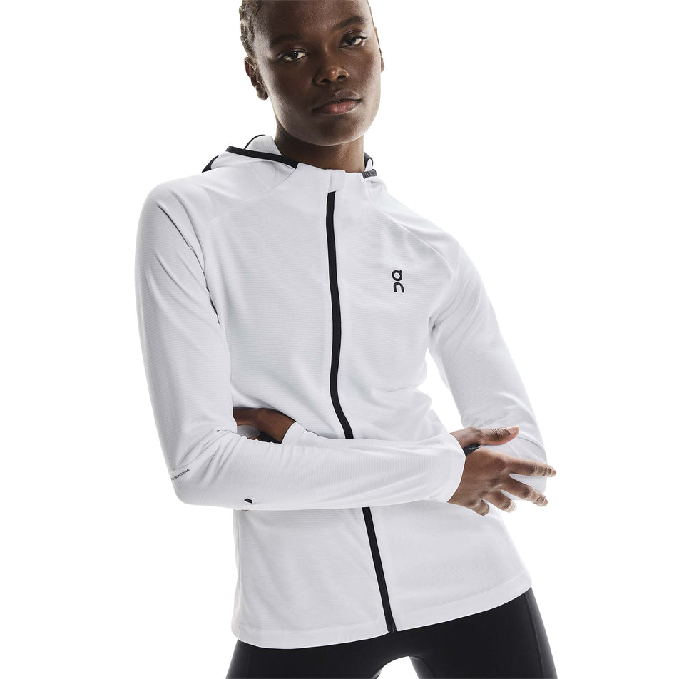 Front view of a model wearing the On Women's Climate Zip Hoodie in the White colourway.
