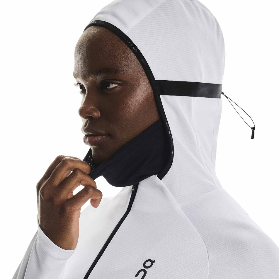 Angled view a model wearing the Women's Climate Zip Hoodie in the White colourway.