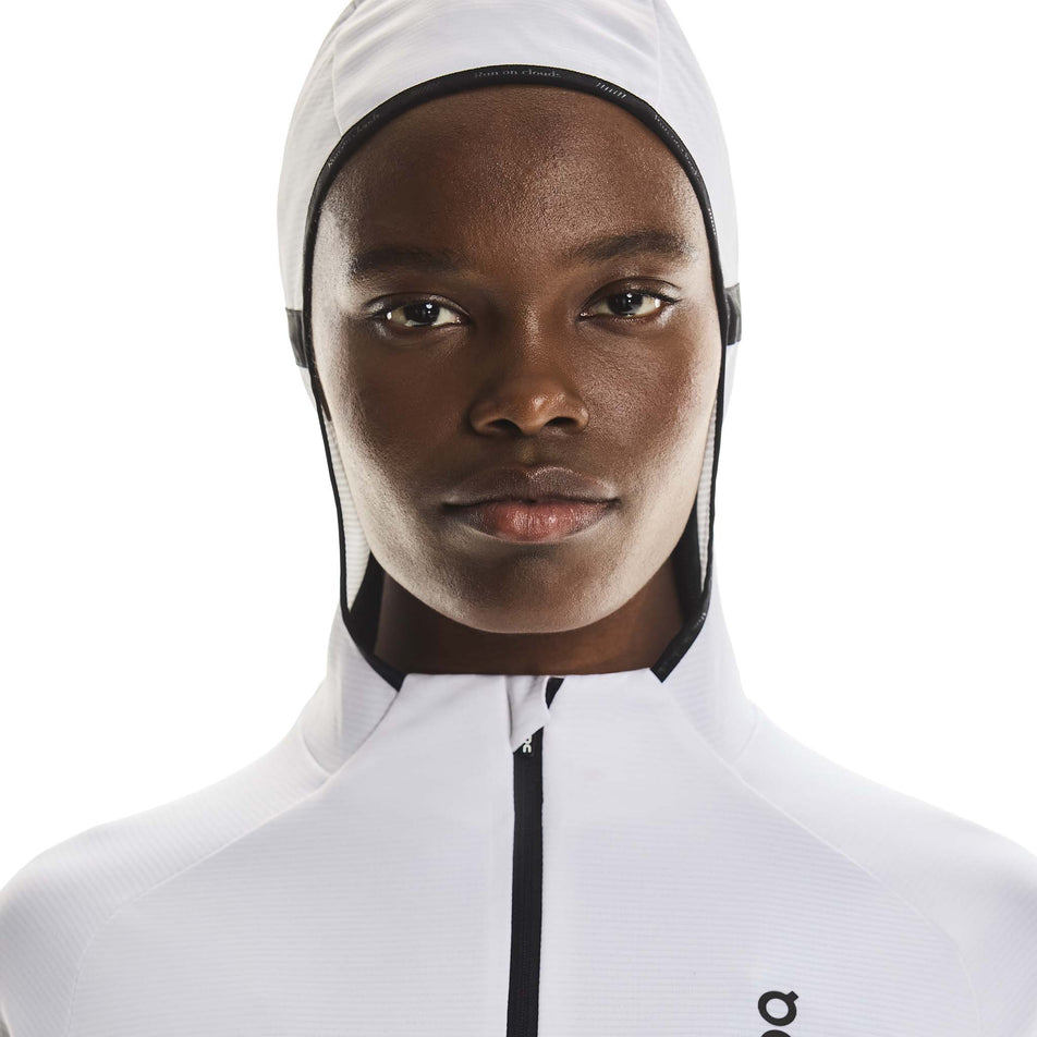 Front view of a model wearing the On Women's Climate Zip Hoodie in the White colourway.