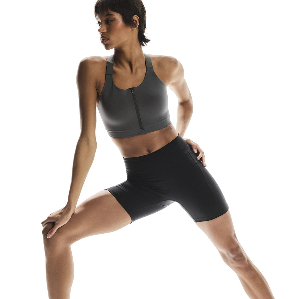 Front view of a model wearing the On Women's Performance Tights Short in the Black colourway. (8715718197410)