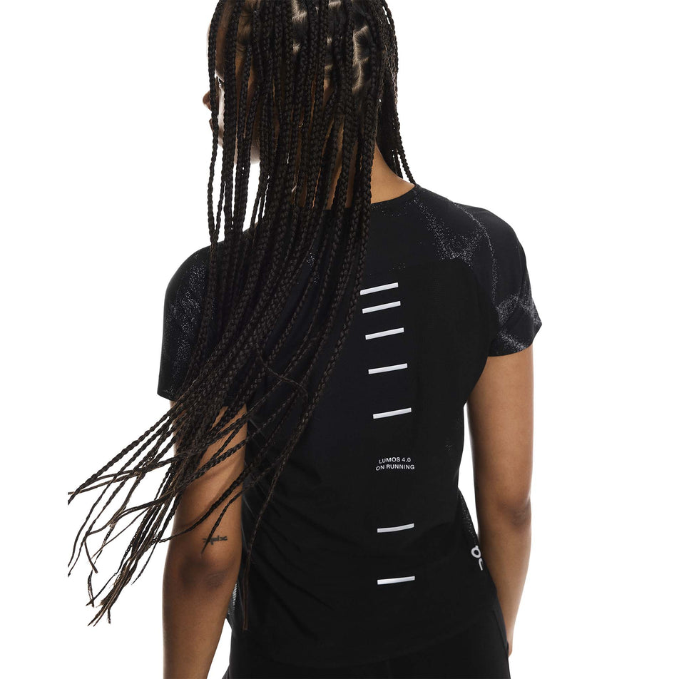 Back view of a model wearing the On Women's Performance-T Lumos in the Black colourway. (8790019342498)