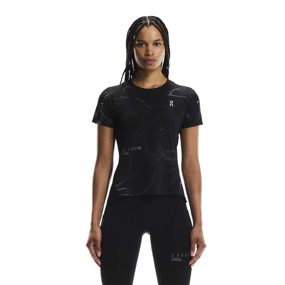 Front view of a model wearing the On Women's Performance-T Lumos in the Black colourway. (8790019342498)