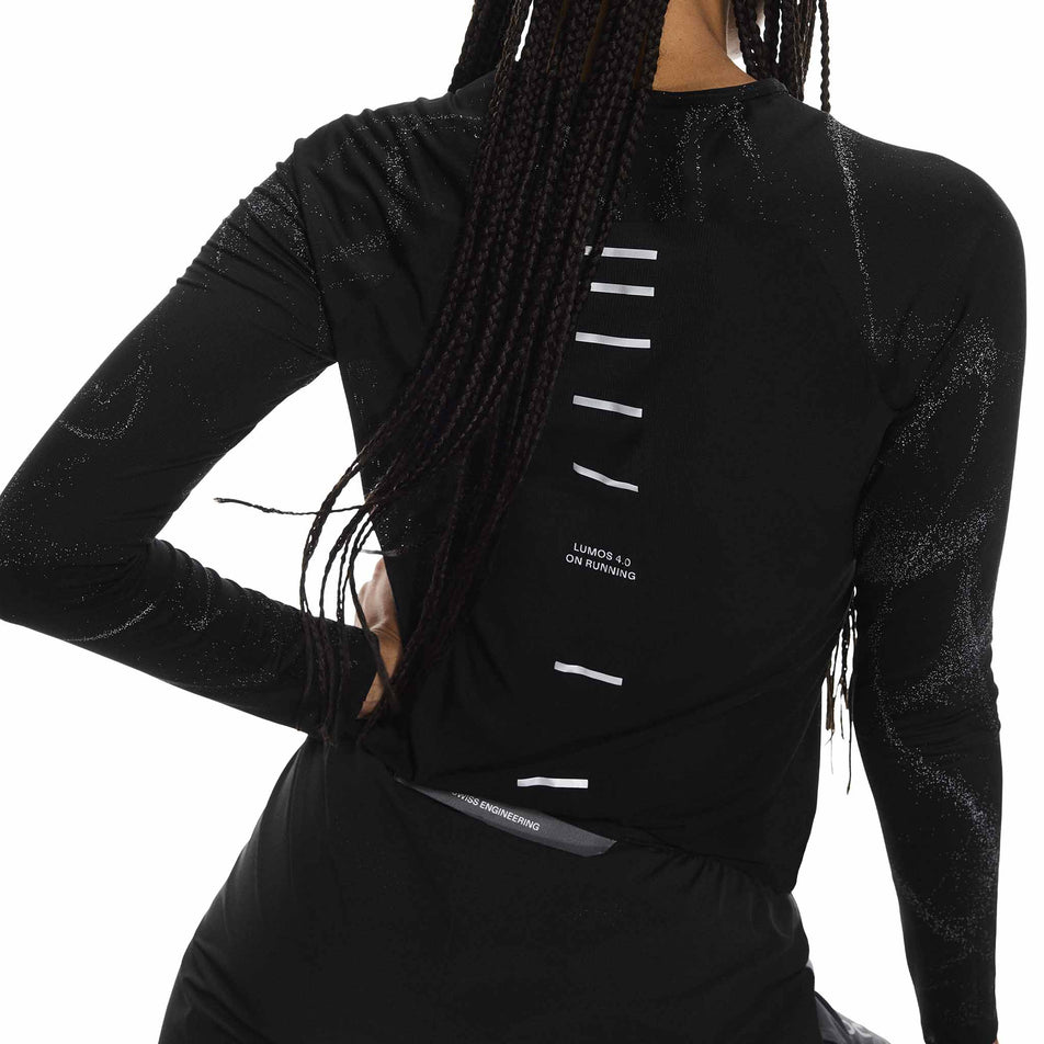 Back view of a model wearing the On Women's Performance Long-T Lumos in the Black colourway. (8790025928866)