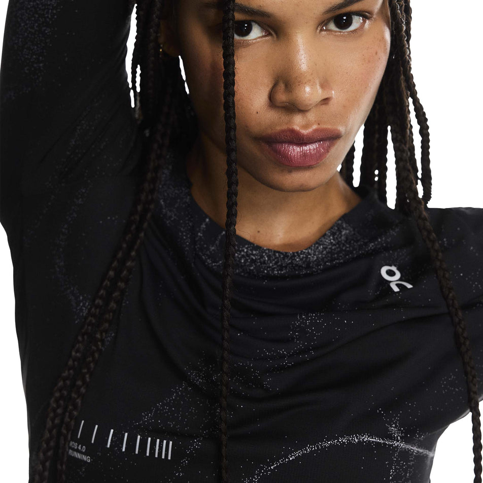 Front view of a model wearing the On Women's Performance Long-T Lumos in the Black colourway. (8790025928866)