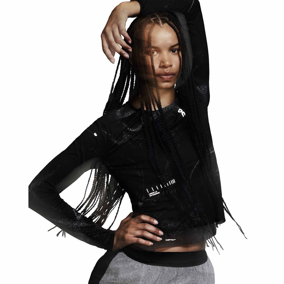 Front view of a model wearing the On Women's Performance Long-T Lumos in the Black colourway. (8790025928866)