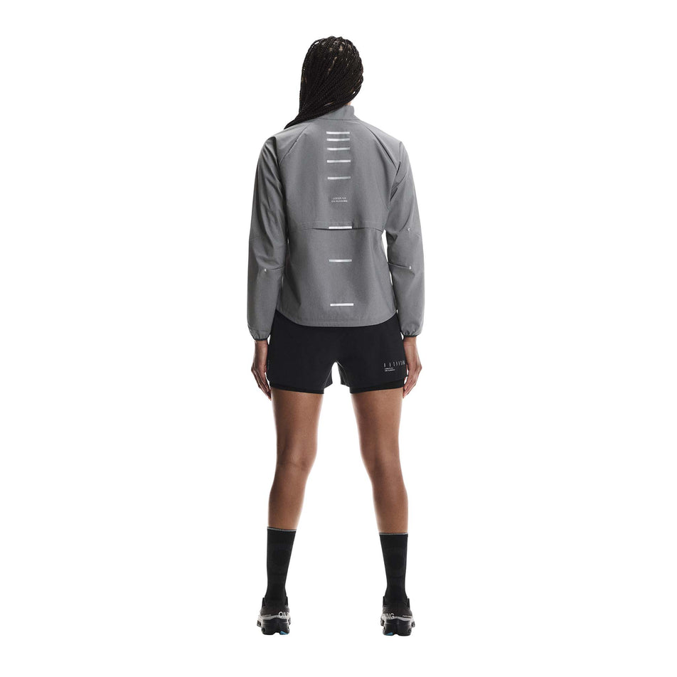Back view of a model wearing the On Women's Weather Jacket Lumos in the Eclipse colourway. (8790034808994)