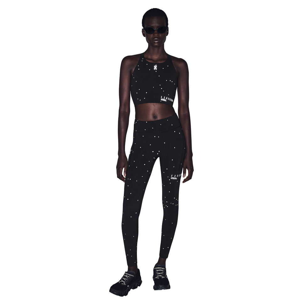 Front view of a model wearing the On Women's Performance Tights Lumos 2.0 in the Black/Eclipse colourway.