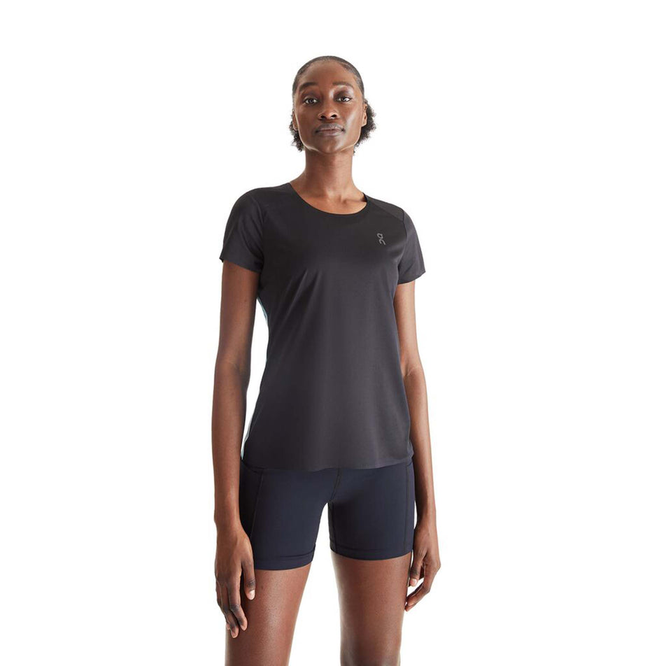 Front view of a model wearing an On Women's Performance T in the Black/Wash colourway (8002756313250)