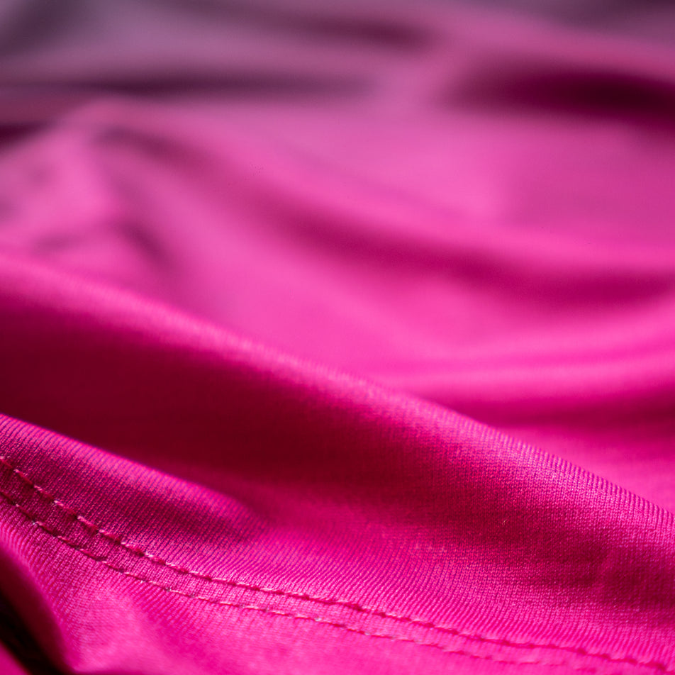 Close-up view of the fabric of the EMF Official Licensed Merchandise | Pressio Men's Prevail Singlet in the Black/Pink colourway.