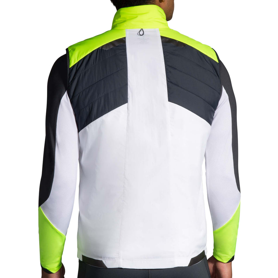 Back view of model wearing a Brooks Men's Run Visible Insulated Vest in the White/Asphalt/Nightlife colourway. Model is wearing also wearing a Brooks long sleeve top. (8059815329954)