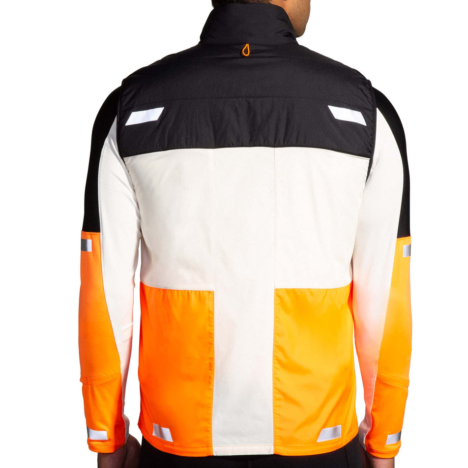Back view of a model wearing the Brooks Men's Run Visible Insulated Vest 2.0 in the Ecru/Fluoro Flash/Black colourway. (8778447224994)