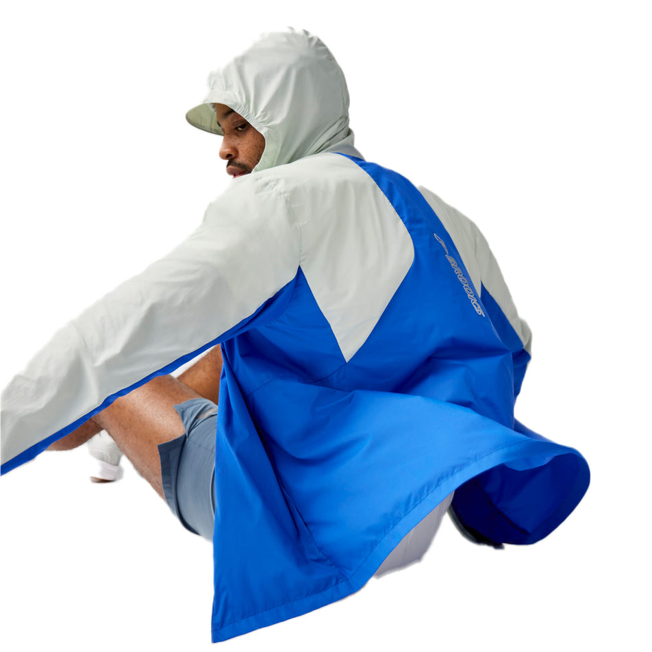 Back view of a model wearing the Brooks Men's Canopy Jacket 2.0 in the Neo Blue/Storm colourway. (8718746484898)