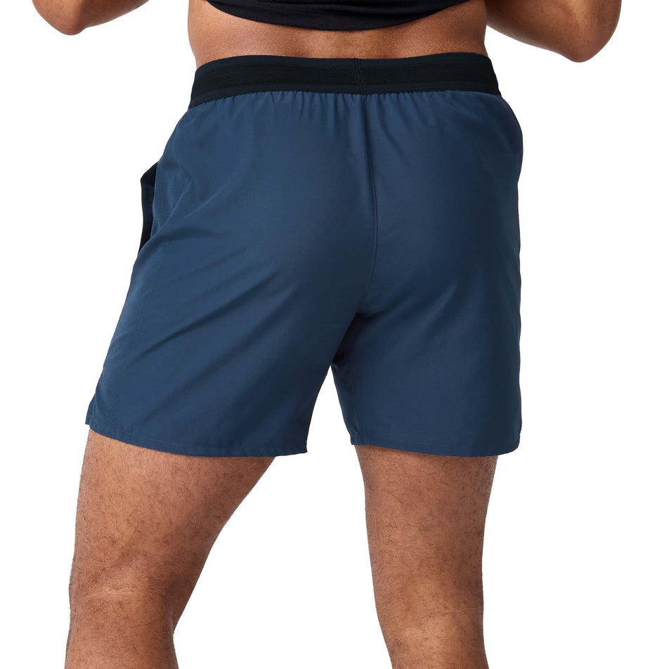 Back view of a model wearing the Brooks Men's Dash 2-in-1 Short in the Midnight Run/Black colourway.