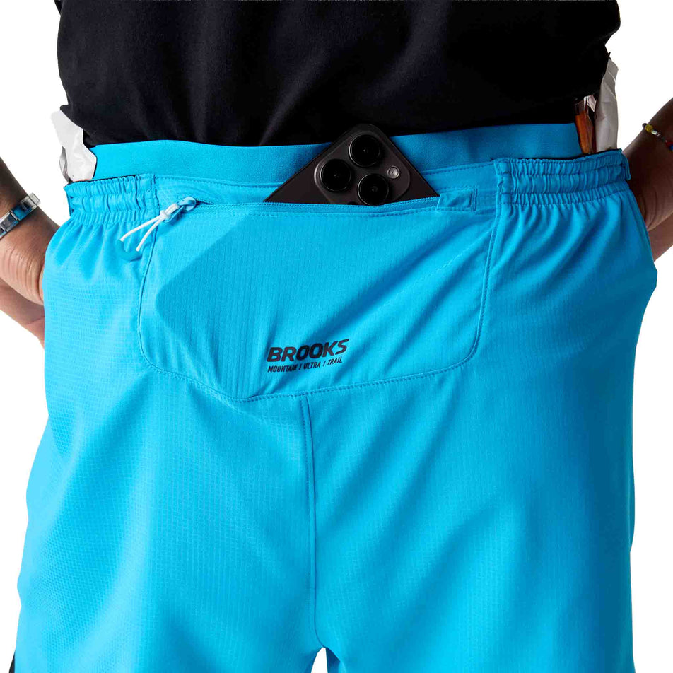Back view of a model wearing the Brooks Men's High Point Cascadia Short in the Blazing Blue/Atomic Blue colourway.