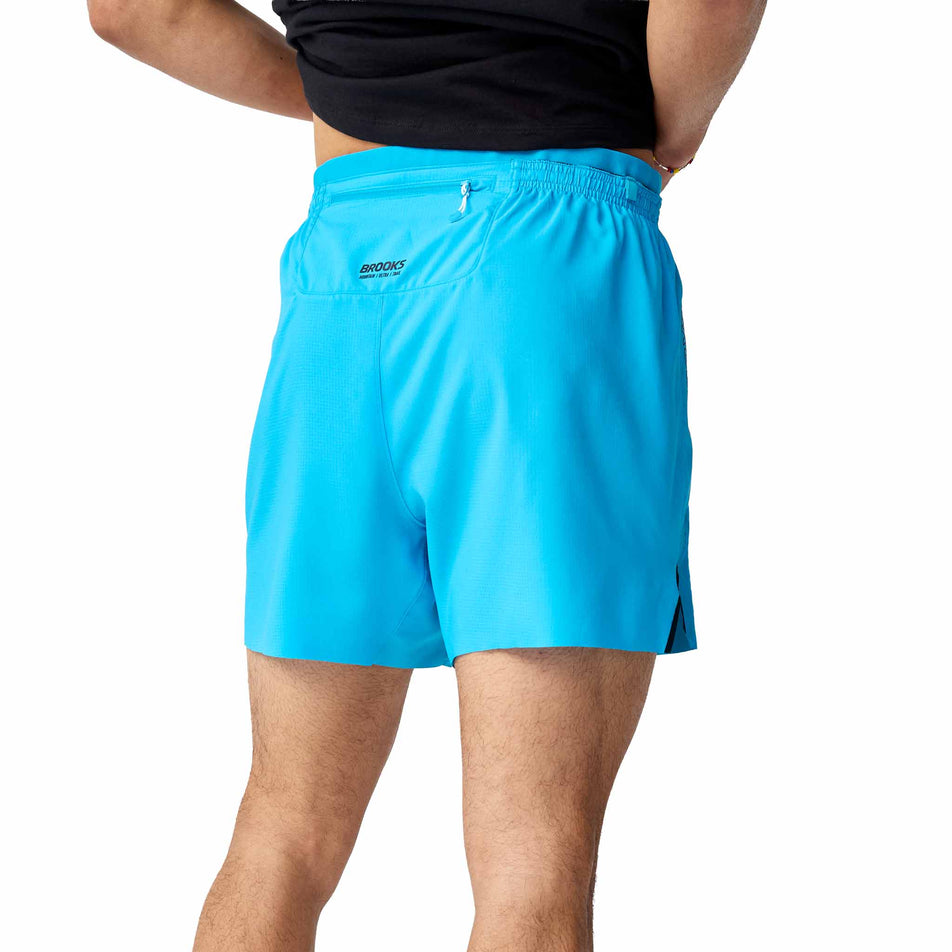 Back view of a model wearing the Brooks Men's High Point Cascadia Short in the Blazing Blue/Atomic Blue colourway.