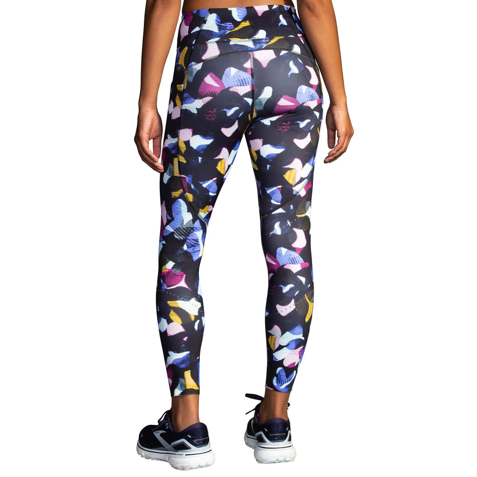 Front view of a model wearing a pair of Brooks Women's 7/8 Tights in the Fast Floral Print colourway (8007499481250)