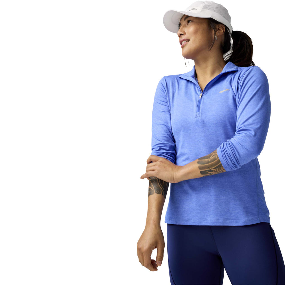 Front view of a model wearing the Brooks Women's Dash 1/2 Zip 2.0 in the Htr Bluebell colourway. (8575029280930)
