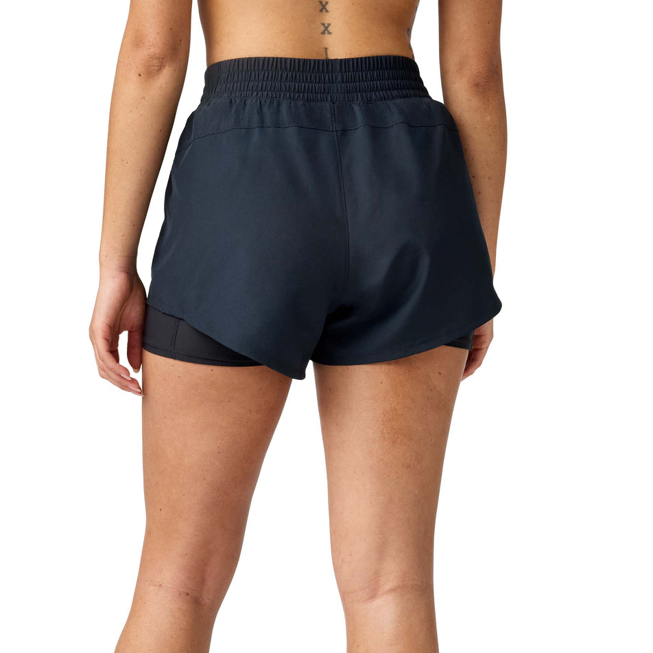 Back view of a model wearing the Brooks Women's Dash 2-in-1 Short in the Black colourway.