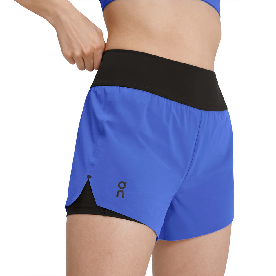 Front view of a model wearing a pair of On Women's Running Shorts in the Cobalt/Black colourway (7926184444066)