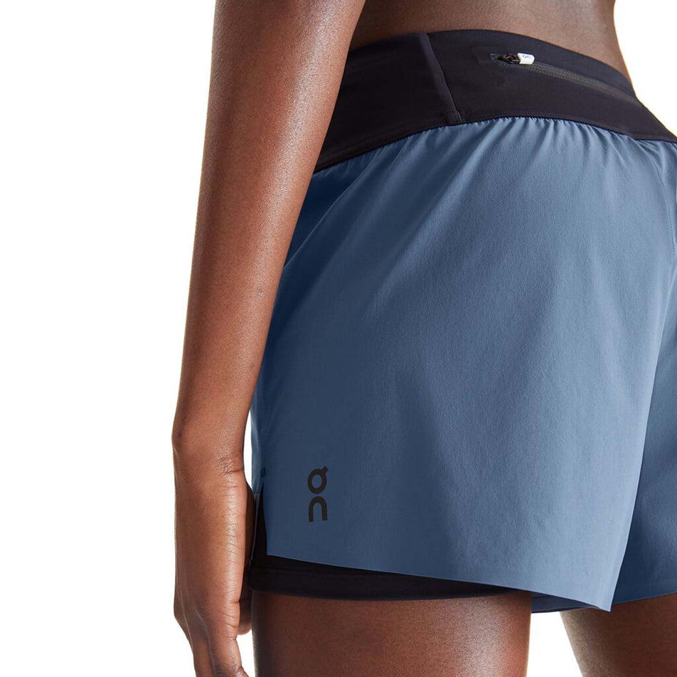 Close-up angled back view of a model wearing a pair of On Women's Running Shorts in the Stellar/Black colourway (8002757591202)