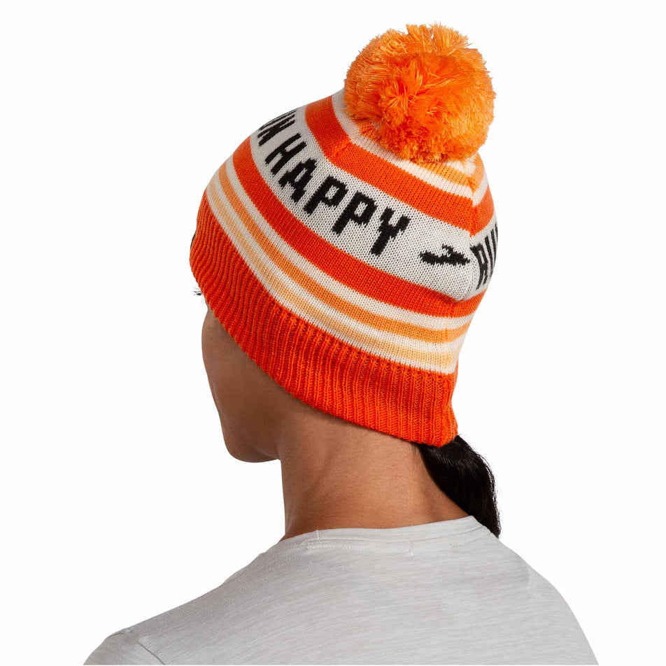 Back view of a model wearing the Brooks Unisex Heritage Pom Beanie in the Fluoro Flash Run Happy colourway. (8511194333346)