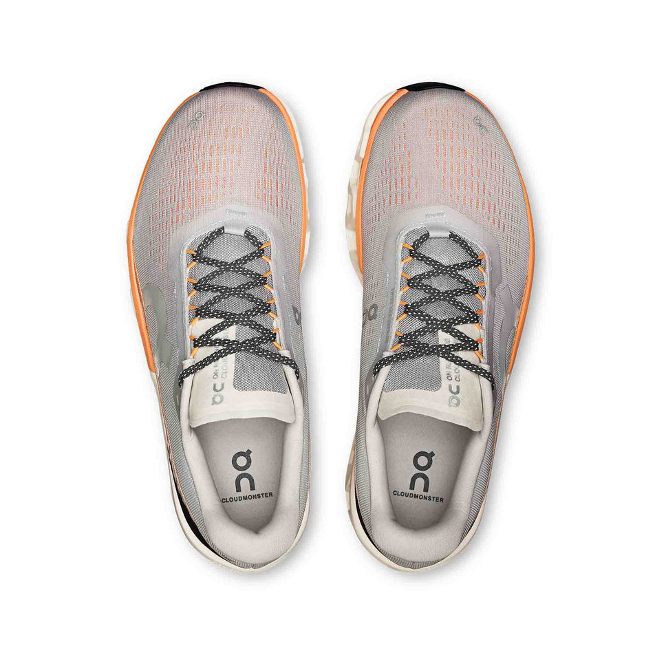 The uppers of a pair of On Men's Cloudmonster 2 Running Shoes in the Glacier/Tangerine colourway. (8714506862754)