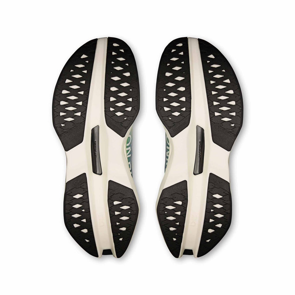 The outsoles of a pair of On Men's Cloudboom Max Running Shoes in the Honeydrew/Lilac colourway. (8714482647202)