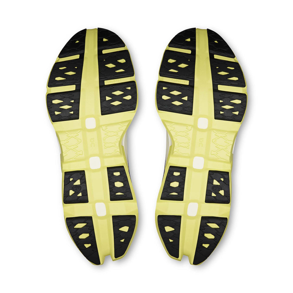 The outsoles of a pair of On Men's Cloudmonster 3 Hyper Running Shoes in the Lily/Limelight colourway.