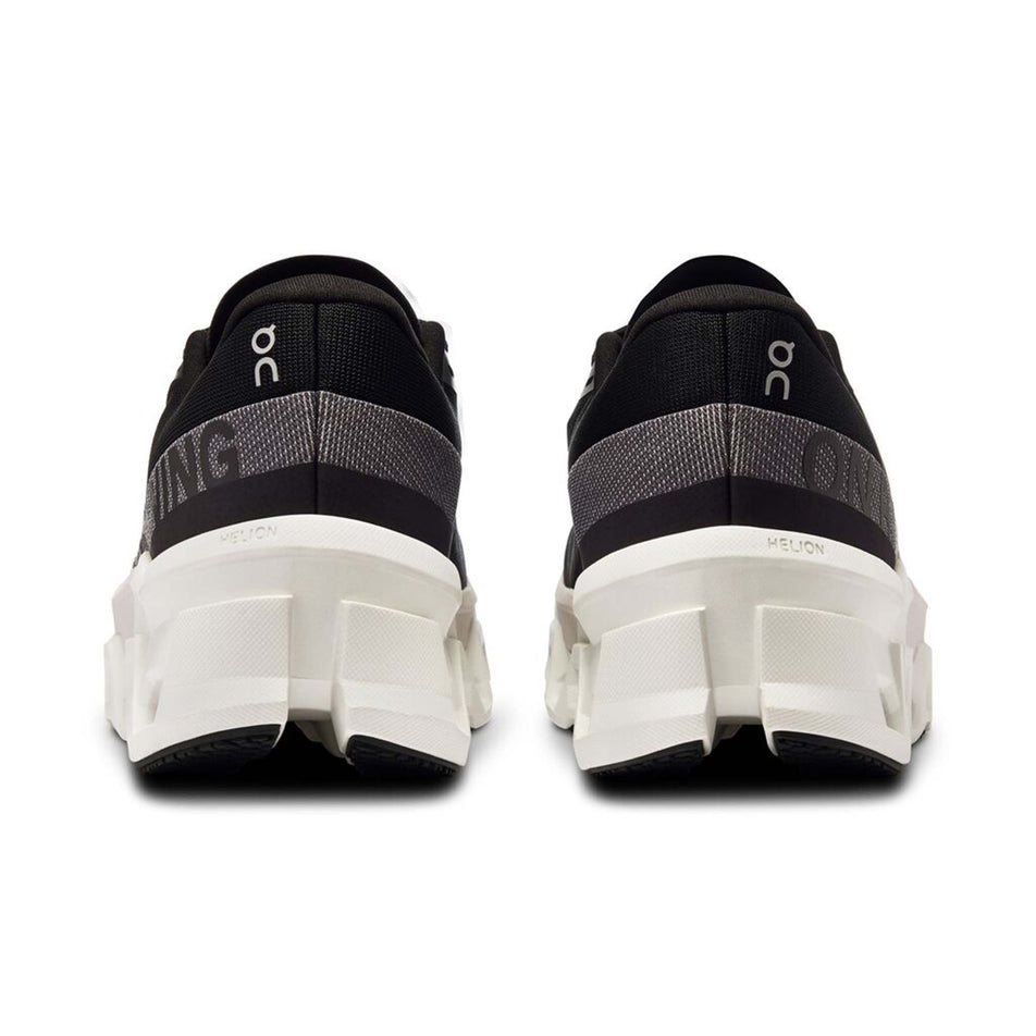The back of a pair of On Women's Cloudmonster 2 Running Shoes in the Black/Frost colourway (8185896599714)