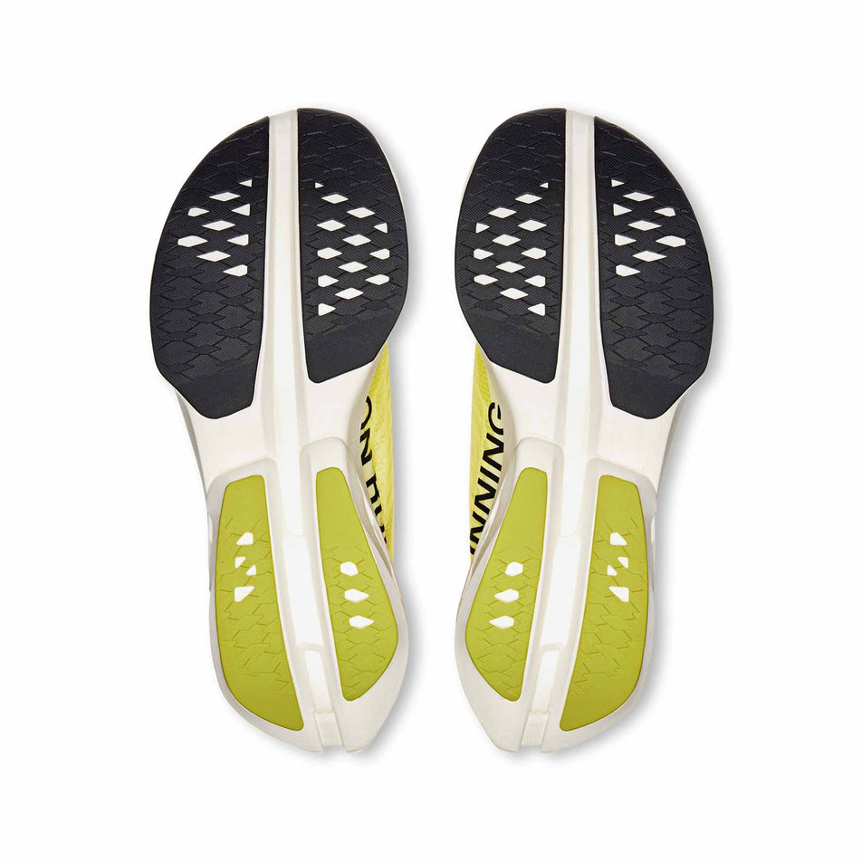 The outsoles on a pair of On Women's Cloudboom Strike Running Shoes in the Limelight/Wolf colourway. (8577861386402)