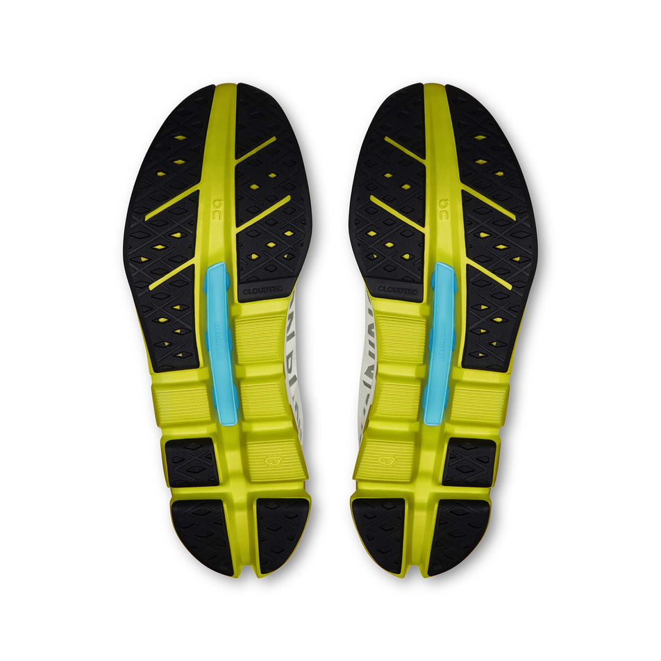 The outsoles of a pair of On Women's Cloudflow 5 Running Shoes in the White/Lime colourway. (8714984226978)