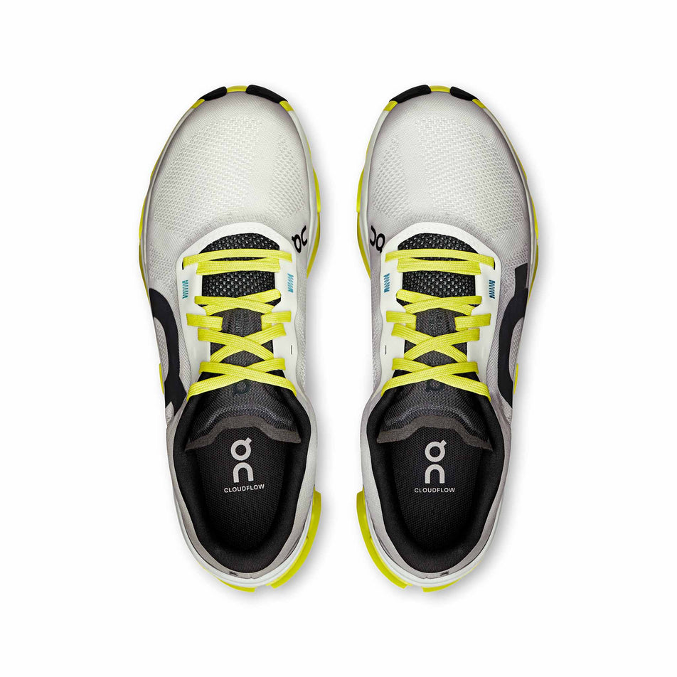 The uppers of a pair of On Women's Cloudflow 5 Running Shoes in the White/Lime colourway. (8714984226978)