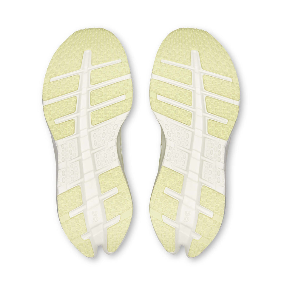The outsoles of a pair of On Women's Cloudrunner 3 Running Shoes in the Seedling/Ivory colourway.