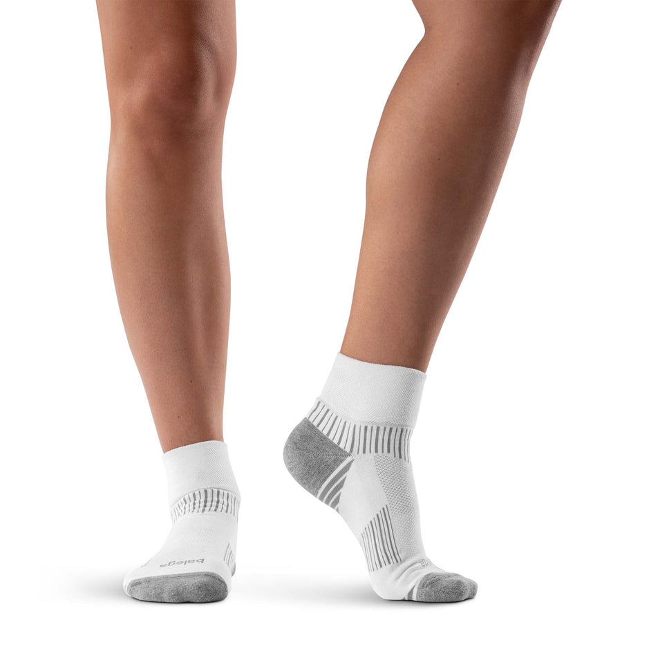 A model wearing a pair of Balega Unisex Enduro Quarter Running Socks in the White/Grey colourway.
