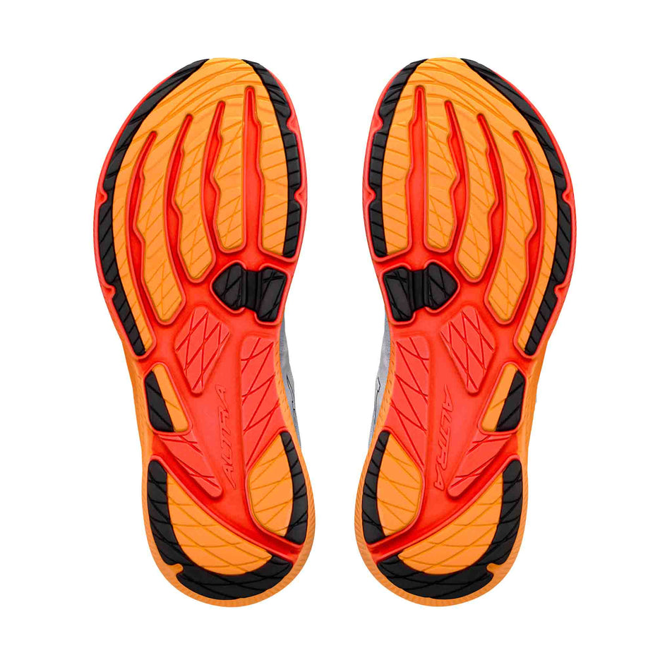 The outsoles of a pair of Altra Men's Experience Flow 3 Running Shoes in the White/Black/Orange Pop colourway.