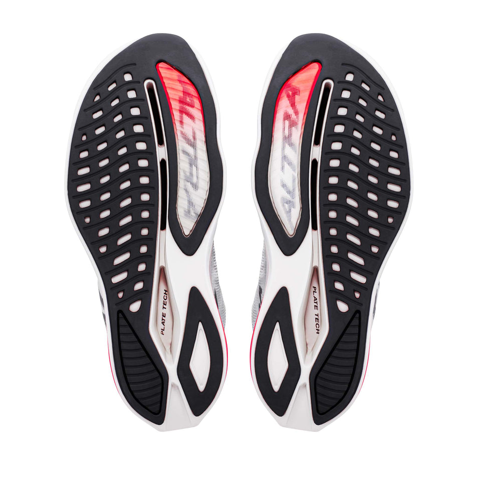 The outsoles of a pair of Altra Women's Vanish Carbon 3 Running Shoes in the White/Black/Fiery Coral colourway.